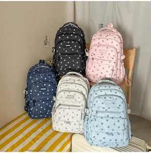 A detailed view of five colorful star-patterned backpacks ideal for school and travel