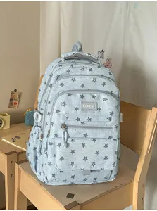 Detailed view of light blue star-patterned backpack in a cozy study room setting