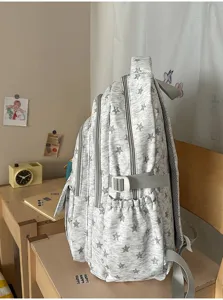 Detailed side view of grey star pattern large capacity school backpack for students