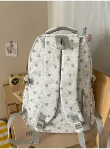 Back view of star pattern school backpack showing padded straps and hidden pocket