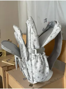 Detail view of the grey star pattern school backpack showing multiple compartments
