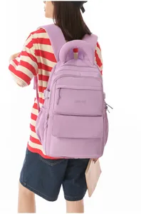 Detail of purple student backpack with embroidered logo and multiple pockets