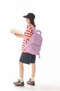 Side view of a purple large capacity school backpack on a model in white background