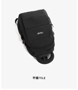 High-angle tiled detail view of the black student backpack featuring embroidered logo