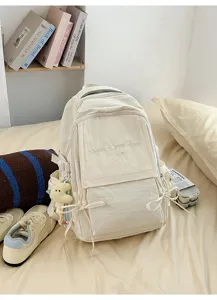 Sac à dos beige minimaliste avec broderie « Have a good day » dans un décor de vie