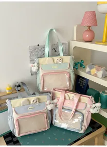 Display of pastel Japanese style Ita bags with transparent window pockets and charms