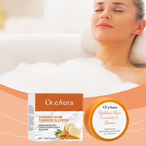 Detailed view of handmade turmeric lemon soap bar with box packaging and rich foam bubbles.