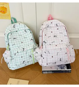 Pair of cute cartoon bear plaid backpacks in pink and green colors with plush teddy charms