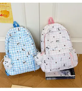 Detailed view of blue and pink plaid school bags with cute cartoon bear prints
