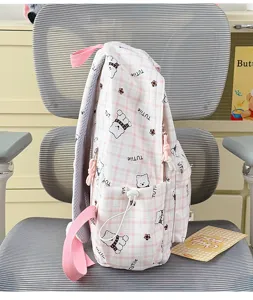 Detailed side view of pink plaid backpack featuring cute cartoon bear pattern and side pocket.
