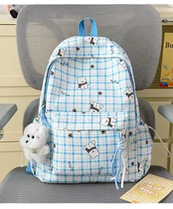 Detailed view of a blue plaid backpack with cute bear patterns and plush charm
