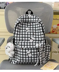 Student backpack detail showing black white grid pattern and cute cartoon bear prints