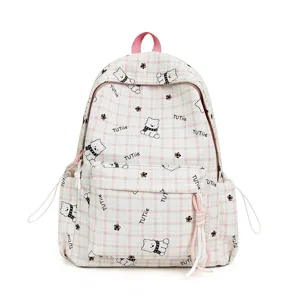 Detailed macro view of pink plaid school backpack featuring cute cartoon bear pattern