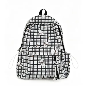 Detail view showing the front of a checkered student backpack with cute cartoon bear patterns