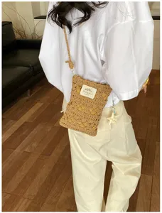 Handmade crochet hollow-out phone bag worn as a crossbody by a model in white shirt