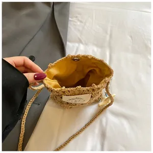 Close-up showing the yellow fabric lining and magnetic buckle of the hand-knitted bag