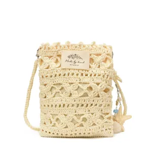 Close-up of handmade cream crochet crossbody phone bag with shell charm and STUDIO label