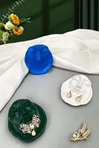 Creative abstract human face resin jewelry tray detail display for home decor storage.