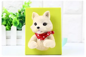 Close-up view of the cute puppy resin wall hook with green backing for plug storage.