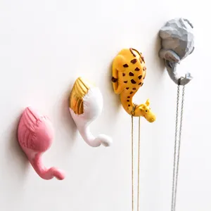 Resin cartoon animal wall hooks detail, elephant giraffe flamingo design for home decor.