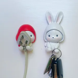 Cute cartoon rabbit wall hook, punch-free sticky key and plug holder for home storage and decor.