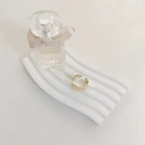 White wave ceramic tray detail shot, minimalist photography prop for aesthetic product display.