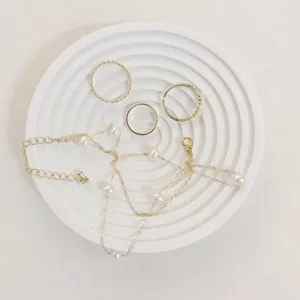 Exquisite detail view of minimalist jewelry and ceramic display tray, elegant aesthetic prop.
