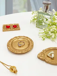 Resin vintage jewelry tray detail showing embossed gold design, elegant home decor photo prop.