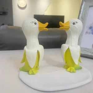 Detailed view of cute banana duck resin ornament, funny desk decor sculpture for home and room.
