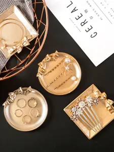 Detail view of Nordic style metallic jewelry tray, gold storage dish for rings and hairpins.