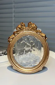 Close-up detail of vintage gold ornate photo frame photography prop for desktop decor