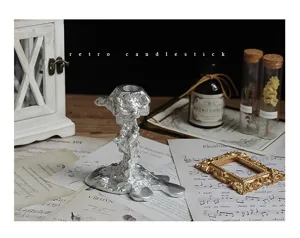 Retro silver melting candlestick detail view, European vintage candle holder tabletop decor.