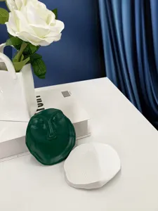 Creative green resin face jewelry dish and tray, perfect for home decor and trinket storage.