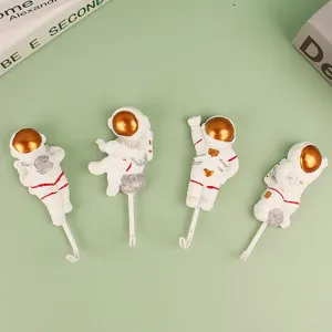 Resin astronaut wall hooks, cute punch-free adhesive decorative clothes hangers for home room decor.