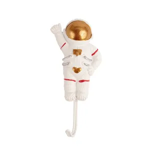 Cute astronaut wall hook made of durable resin, punch-free adhesive design for home decor.