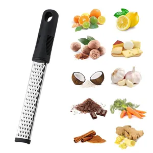 Stainless steel lemon zester and cheese grater kitchen tool for citrus, ginger, and garlic.
