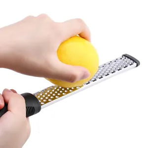 Stainless steel lemon zester and cheese grater with comfortable handle for kitchen cooking.