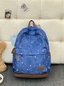 Vintage blauer Rucksack mit weißem Sternenmuster und braunen Kunstleder-Akzenten.