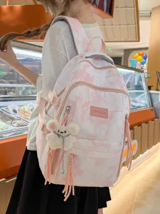Stylish pink and white tie-dye large capacity backpack worn by model in a mall.