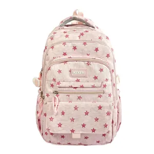 Detailed front view of pink school backpack featuring a red star pattern and multiple pockets