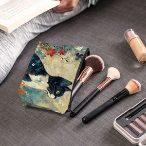 Detail shot of cute cat print makeup bag with brushes on grey fabric background