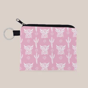 Detailed view of pink fabric coin purse with white highland cow and cactus pattern print