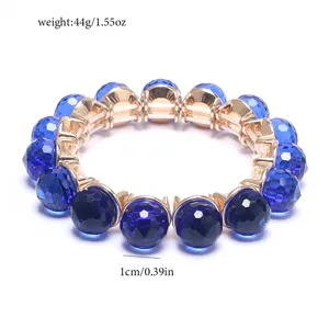 Close-up of blue crystal bead and gold metal setting detail showing texture and size.