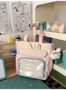 Pink Japanese style student Ita-bag with clear display window and cute plush charm detail