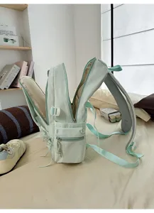 Vue détaillée de côté d'un sac à dos d'étudiant vert menthe ouvert avec compartiments