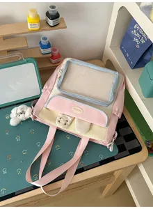 Detailed view of pink sweet Japanese style Ita bag with clear window and plush dog charm