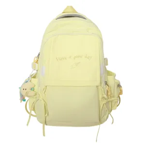 Détail du sac à dos jaune pour écolière avec broderie et porte-clés lune en peluche
