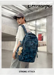 Male model showcasing a trendy blue camouflage student backpack with large capacity and bear charm