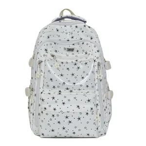 Vue détaillée d'un sac à dos d'école blanc avec motifs d'étoiles et poche transparente pour filles