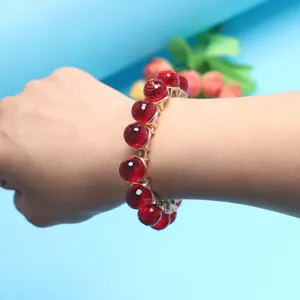 Red faceted crystal bead bracelet detail view, elegant gemstone elastic stretch wrist jewelry.